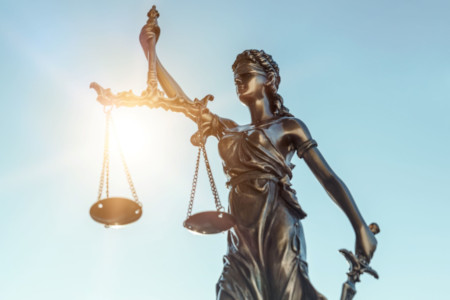 Statue of woman holding weighing scales