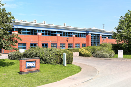 Cross north site factory with blue sky and trees