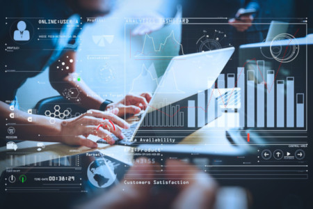 overlaid graphics of laptop and technology showing charts and graphs