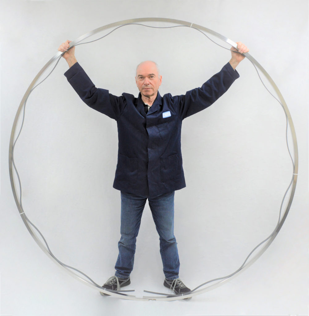Man standing inside large sealing ring